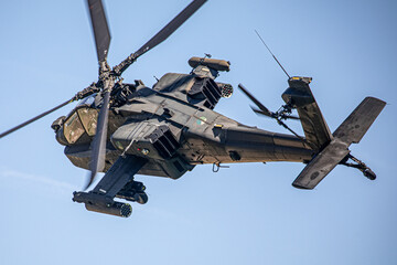 Fototapeta premium Military Apache Helicopter Flying at Low Altitude