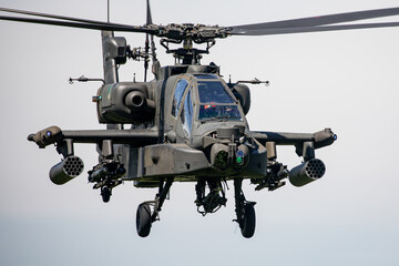 Fototapeta premium Military Apache Helicopter Flying at Low Altitude