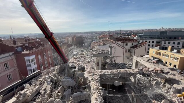 Building demolition site with crane and workers in the city of madrid