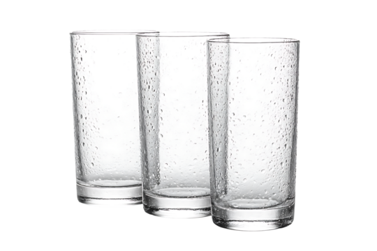 Set of three tall, clear highball drinking glasses covered in fresh condensation or water droplets isolated on transparent background