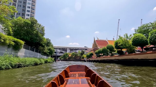 Big Golden Buddha Statue in Wat Pak Nam Phasi Charoen or Pak Nam Temple - Famous for large seated Buddha that is the largest in Bangkok Thailand - Seen From Canal Boat