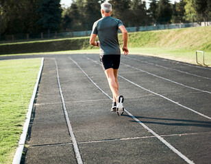 athlete jogging on track, back view