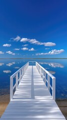 Obraz premium Expansive White Wooden Pier Stretching Across Calm Reflective Blue Water Under a Bright Sunny Sky With Scattered Clouds