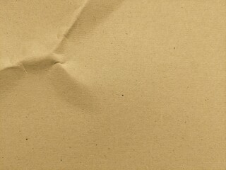Crumpled brown kraft paper texture background with copy space for design. Old vintage paper surface with natural wrinkles and rough texture.