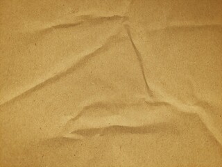 Recycled brown paper crumpled texture background. Abstract wrinkled and folded craft paper surface. Crumpled brown recycle paper background with copy space for text.