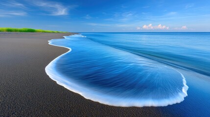 Long Exposure Photo Of Ocean Waves Rolling Over Dark Volcanic Sand Beach Under A Clear Blue Sky