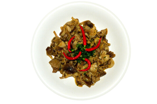 Dish with sautéed mushrooms garnished with fresh chilli peppers and chopped parsley,  isolated on white