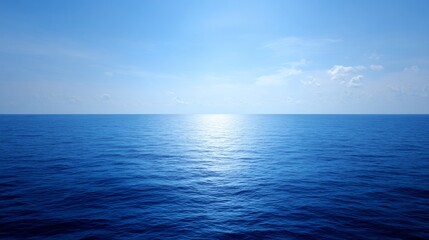 Obraz premium The clear blue ocean unfolds as a limitless panorama at sunrise, meeting the eye at every point on the horizon