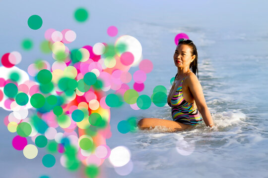 Woman in swimsuit and bokeh on beach