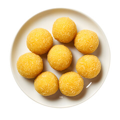 A top down view of eight yellow balls on a white plate