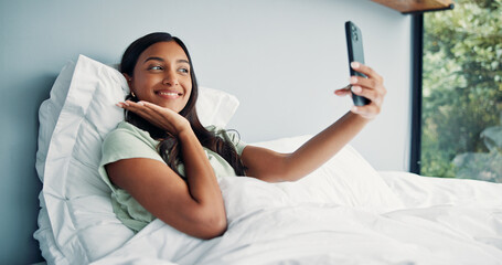 Photography, happy woman and pose for selfie in bed, cozy morning and smile for profile picture update. Relax, social media post and Indian person with wake up photo, comfortable and rest in home