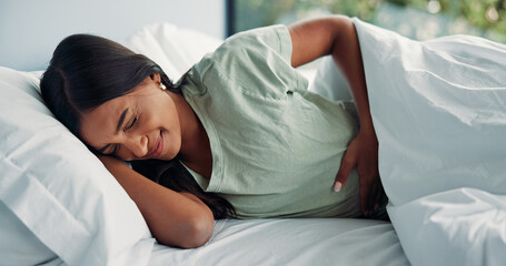 Pain, menstruation and woman in house with massage, discomfort and stomach ache in symptoms....