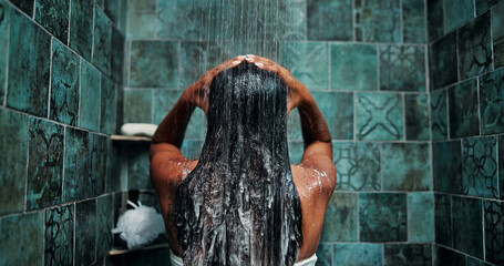 Shower, woman and shampoo for hair care, water or clean with morning routine in bathroom. Foam,...