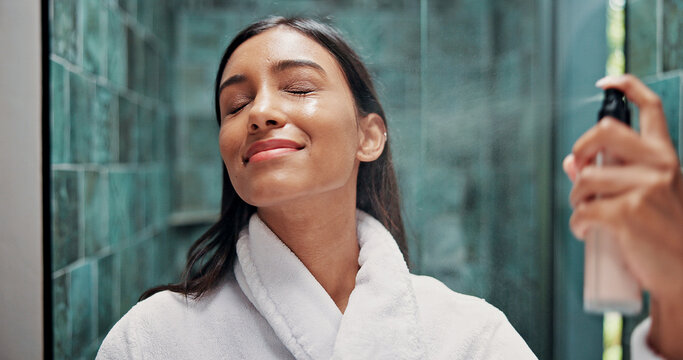 Woman, skincare or apply with face mist in bathroom for hydration, dermatology or beauty cosmetic. Female person, or spray bottle in home with facial product, glowing skin or hyaluronic acid benefits