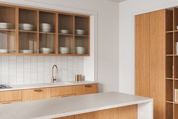 Modern minimalist kitchen interior with wood cabinetry, fluted glass doors, white tile backsplash, and brass fixtures in stylish neutral design concept. 3D Rendering © ImageFlow