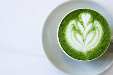 Minimalist Close Up Matcha Latte with Floral Art in a White Cup