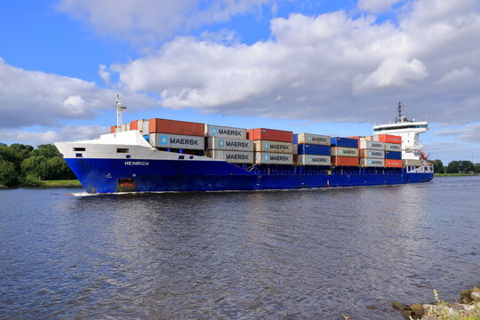 Rendsburg, Germany - August 22 2025: cargo ship pass beneath the Rendsburg High Bridge on the Kiel Canal