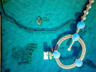 Dolphin Reef is a horseshoe-shaped sea-pen where bottlenose dolphins in the Gulf of Eilat in the northern-eastern Red Sea near the city of Eilat in southern Israel swim in and out of top view