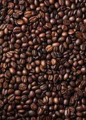 Fototapeta premium background of black coffee beans with a black coffee cup