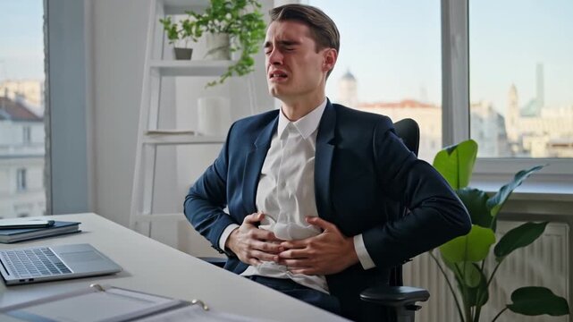A man in a suit clutches his stomach in discomfort and pain, showcasing a need for medical attention Stock Video