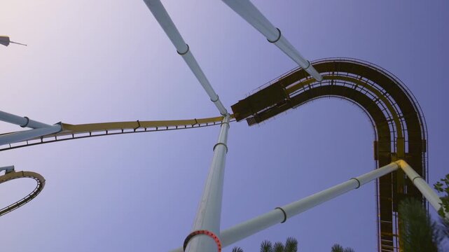 Roller coaster track with riders looping upside down