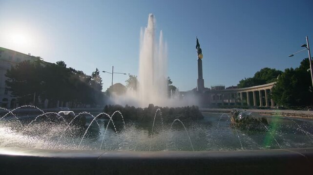 Hochstrahlbrunnen fountain in Vienna Austria with clear blue sky and surrounding monuments showing architecture and culture in the center of the European capital
