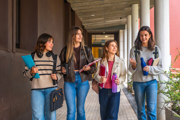 Group of university students walking and talking on campus