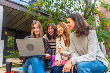 Fototapeta premium University students studying together laughing at campus