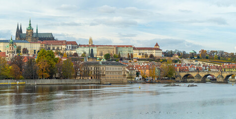 Colourful, autumn panorama of Prague from the river side, in daylight, with the Royal Hill (Hradcany)