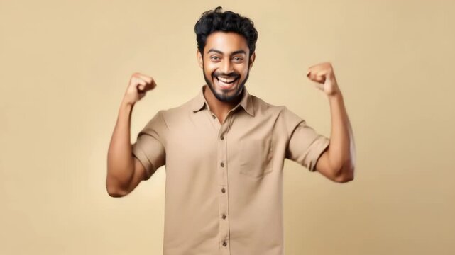 A man smiling with fists raised high, ready to deliver a punch line joke.