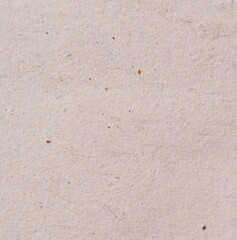 Close-Up of Recycled Paper Surface with Visible Fibers and Specks