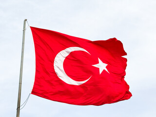 Turkish national flag waving in the wind against cloudy sky
