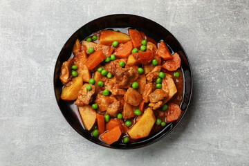 Delicious cooked stew on grey table, top view