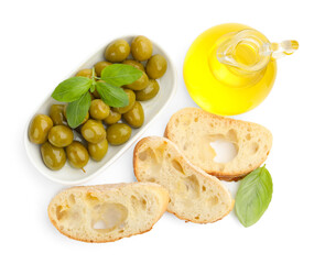 Pieces of fresh ciabatta, oil, olives and basil isolated on white, top view