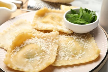 Delicious ravioli with cheese and parsley on table, closeup