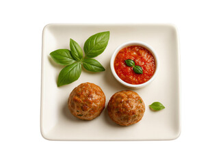 Deliciously seasoned meatballs served with fresh basil and a side of vibrant tomato sauce on a white square plate