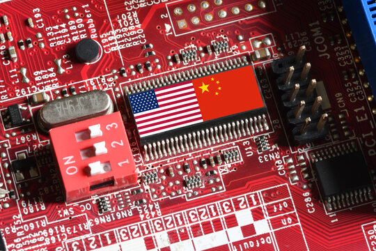 Flag of the Republic of China and the United States on microchip of a PC Motherboard. Concept for world supremacy in microchip and semiconductor manufacturing.