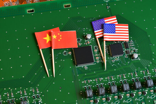 Flag of the Republic of China and the United States on microchip of a PC Motherboard. Concept for world supremacy in microchip and semiconductor manufacturing.