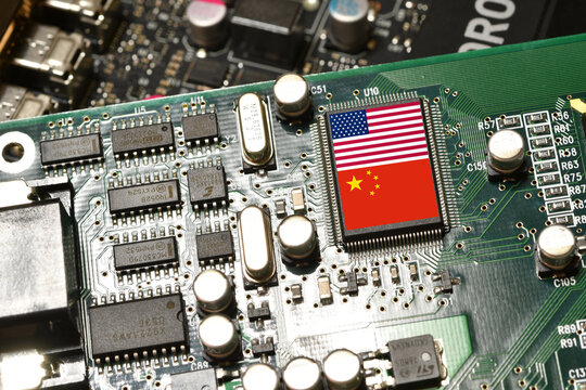 Flag of the Republic of China and the United States on microchip of a PC Motherboard. Concept for world supremacy in microchip and semiconductor manufacturing.