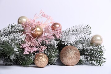 Beautiful Christmas tree branches with decor on white background, closeup