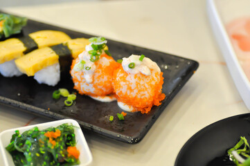 shrimp egg rolls or rice topped with fish or Japanese rolls