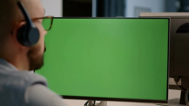 A person working on computer with green screen Stock Video