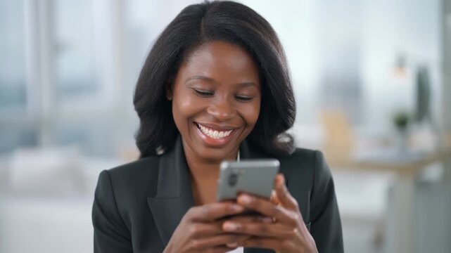 A portrait of a beautiful woman with a mobile phone, engrossed in it with a joyful smile Stock Video - Powered by Adobe