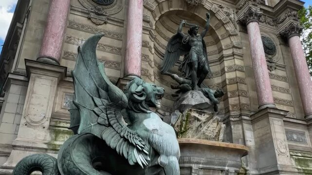 Dynamic shot of Fontaine Saint-Michel with bronze dragon and Saint Michael statue.