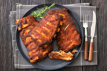 bbq baby pork ribs with fresh rosemary on a plate