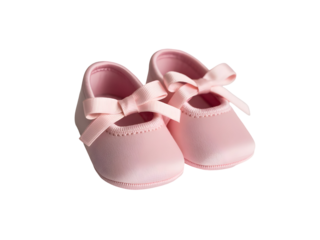 Pair of delicate pink satin baby booties with ribbon bows isolated on a black background, symbolizing new life and celebration.