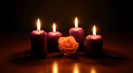 A serene arrangement of four lit purple candles and a delicate peach rose casting a warm glow in the dimly lit space