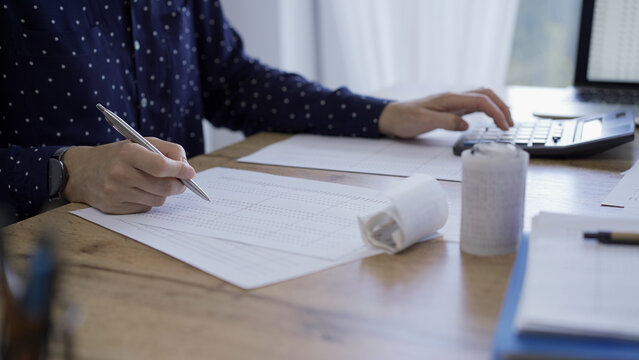 Accountants or auditors reviewing financial documents while usin - Powered by Adobe