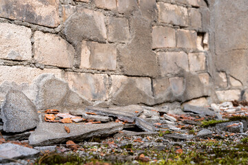 Destruction on an old white brick wall.The building needs to be repaired.