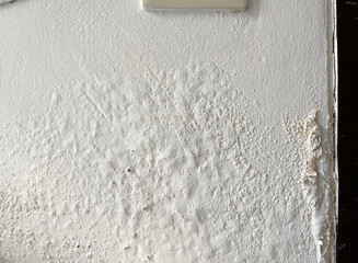 Damped, musty old painted wall. Closeup textured exterior toilet wall in room at dhamma retreat center, Saraburi, Thailand. 25 OCT 2025. A.M.